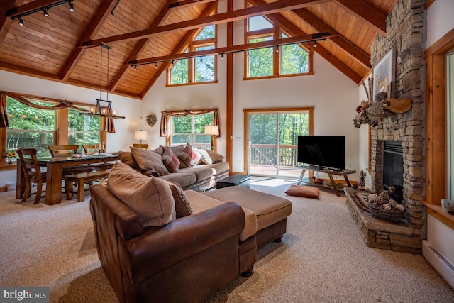 carpeted living room with wood ceiling, a baseboard radiator, a stone fireplace, high vaulted ceiling, and beam ceiling