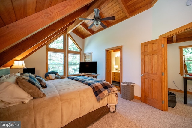 carpeted bedroom with beamed ceiling, high vaulted ceiling, ceiling fan, wooden ceiling, and ensuite bathroom