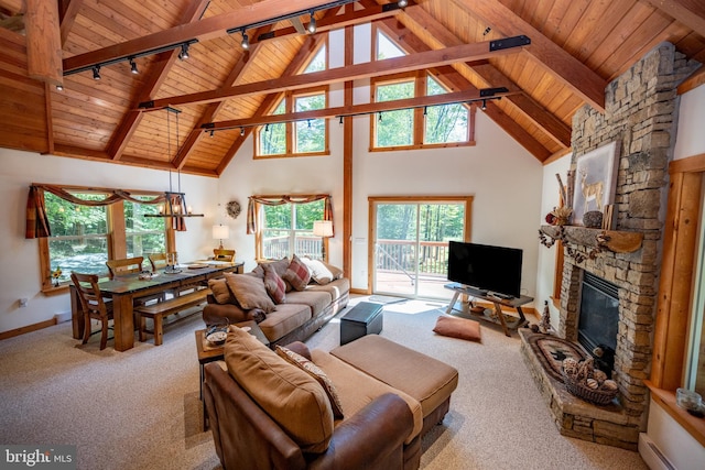 living area featuring wooden ceiling, beamed ceiling, carpet, a fireplace, and a baseboard heating unit