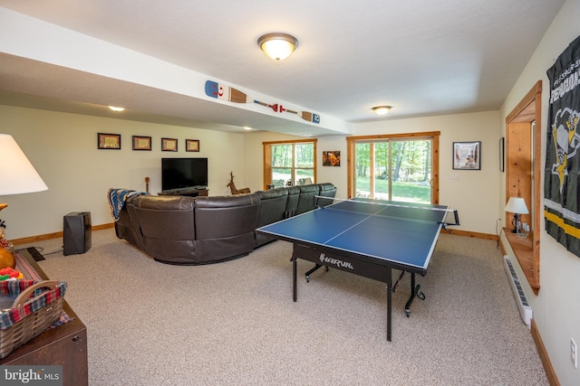 rec room with carpet, a baseboard radiator, and baseboards