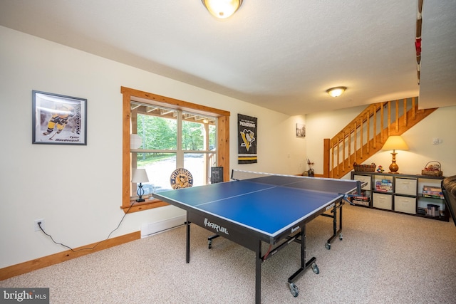 rec room featuring carpet floors, baseboards, and a textured ceiling