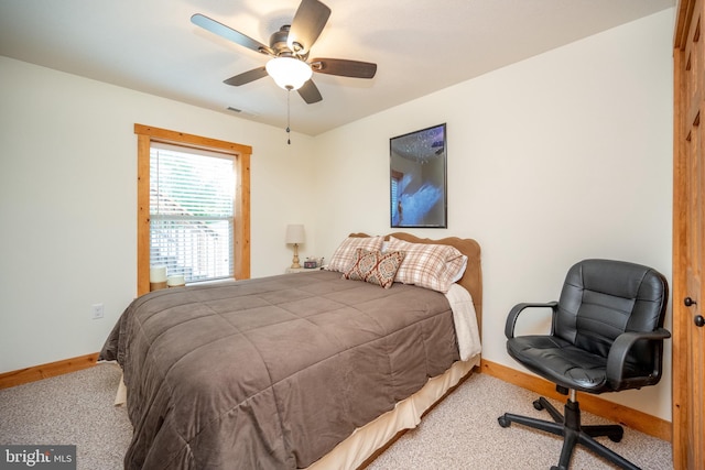 carpeted bedroom featuring a ceiling fan and baseboards