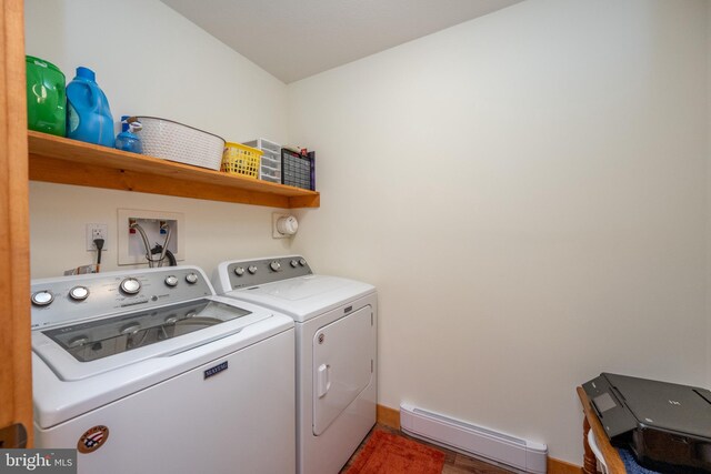 laundry room with a baseboard heating unit and washer and dryer