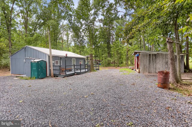 view of yard with a storage shed and a deck