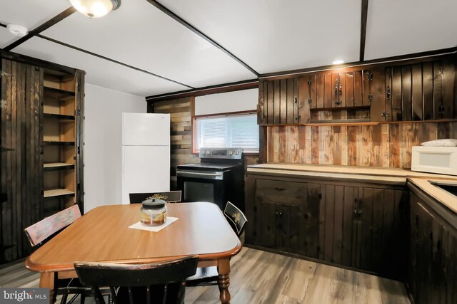 kitchen featuring light hardwood / wood-style floors, white appliances, and dark brown cabinets