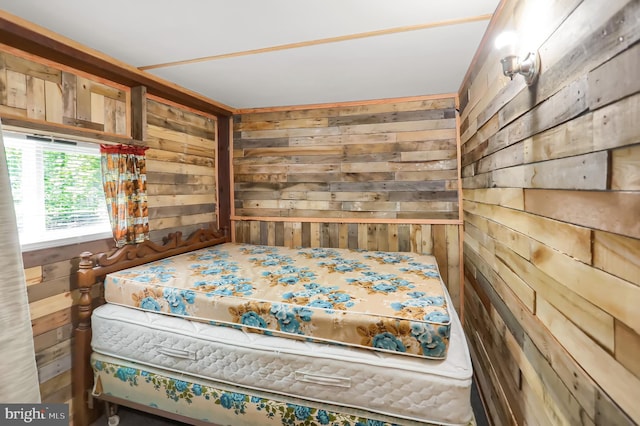 bedroom featuring wooden walls