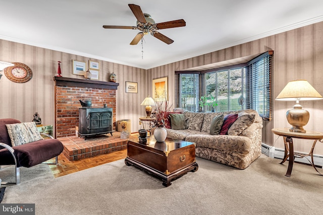 living room with ornamental molding, ceiling fan, parquet floors, and a wood stove