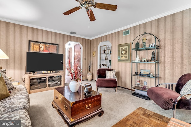 living room with light carpet, ceiling fan, and crown molding