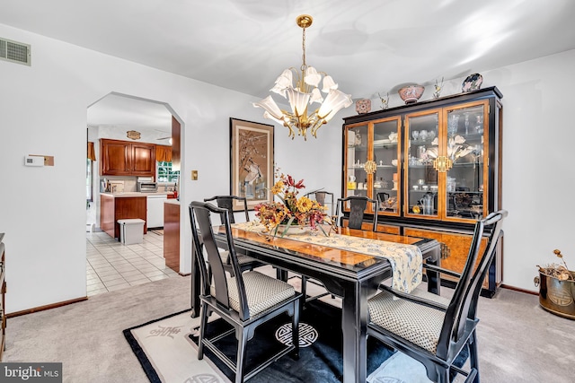 tiled dining space with a chandelier