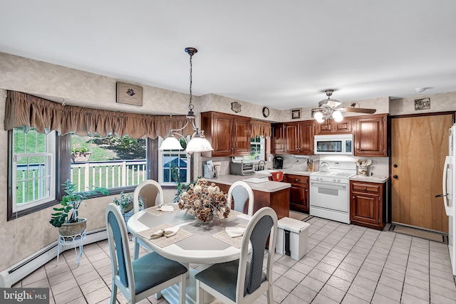 tiled dining area with baseboard heating and ceiling fan