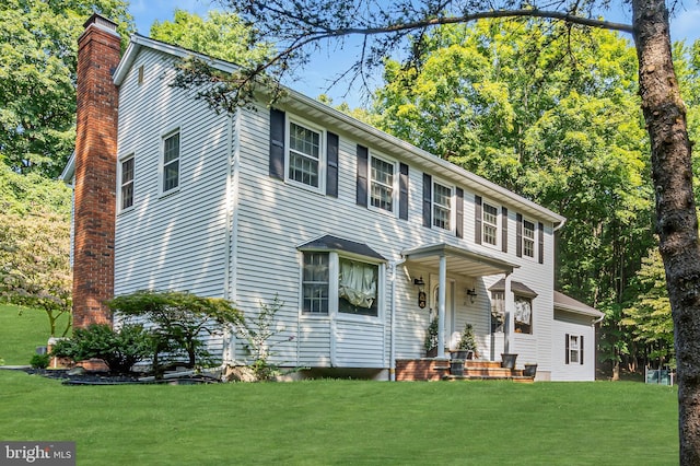 colonial-style house with a front yard