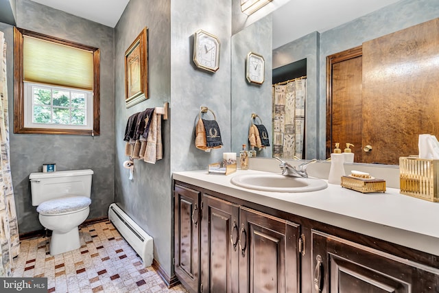 bathroom with a baseboard heating unit, vanity, toilet, and tile patterned floors