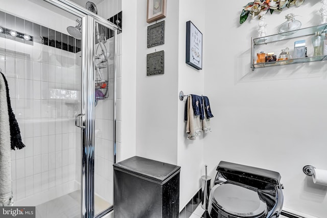 bathroom featuring toilet and walk in shower