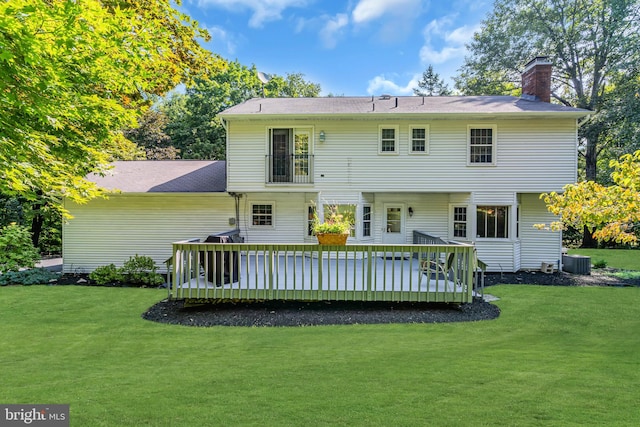 rear view of house with central air condition unit, a yard, and a deck