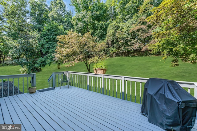 wooden deck featuring a yard and grilling area