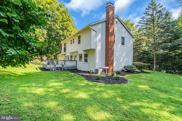 exterior space with a wooden deck and a yard