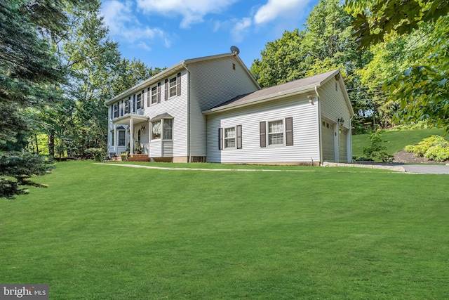 view of front of property featuring a garage and a front lawn