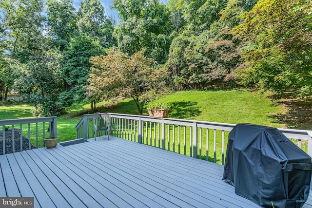 wooden terrace featuring a yard and grilling area