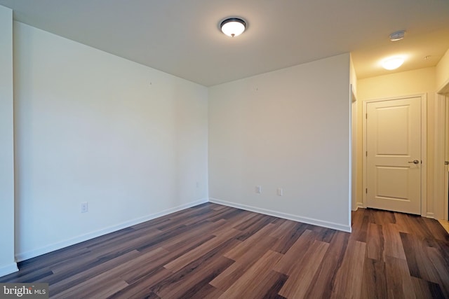 spare room featuring dark wood-type flooring