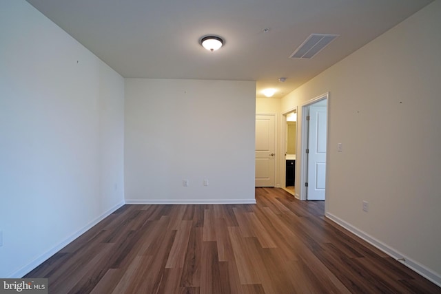 unfurnished room featuring dark hardwood / wood-style flooring