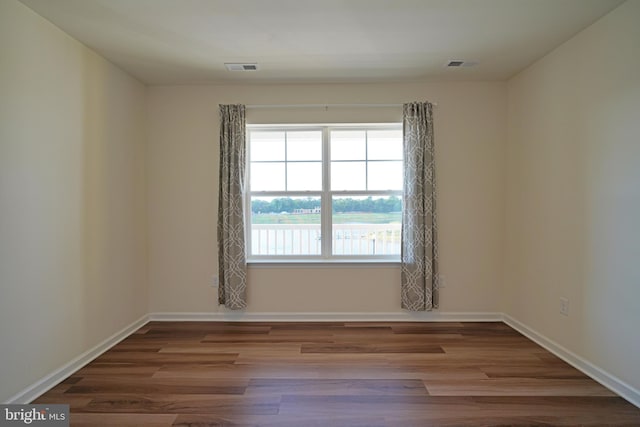 spare room with hardwood / wood-style flooring