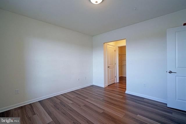 empty room with dark hardwood / wood-style floors