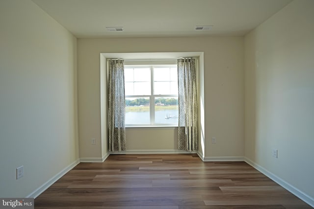 unfurnished room featuring hardwood / wood-style floors