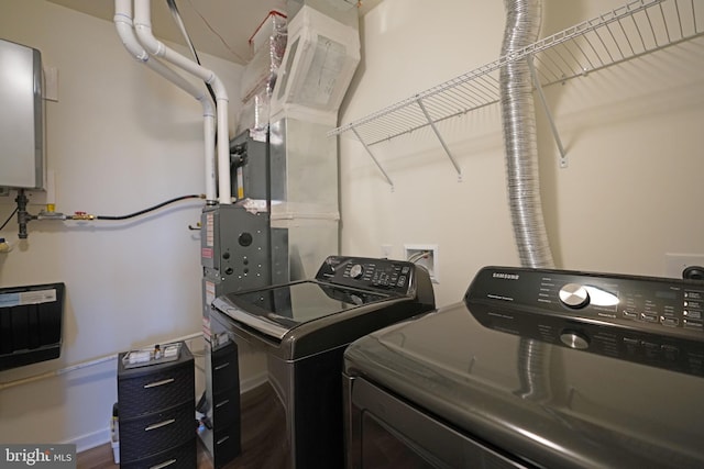 laundry room featuring hardwood / wood-style floors and washer and clothes dryer