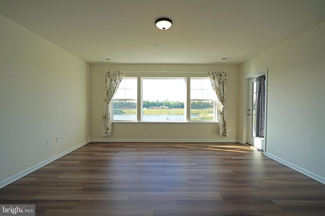 spare room with wood-type flooring