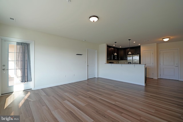 unfurnished living room featuring hardwood / wood-style floors