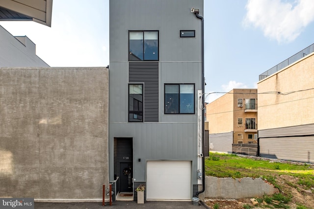 back of property featuring a garage