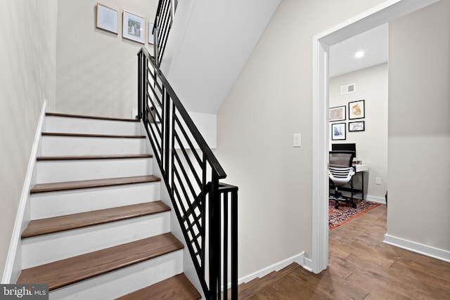 staircase featuring hardwood / wood-style floors