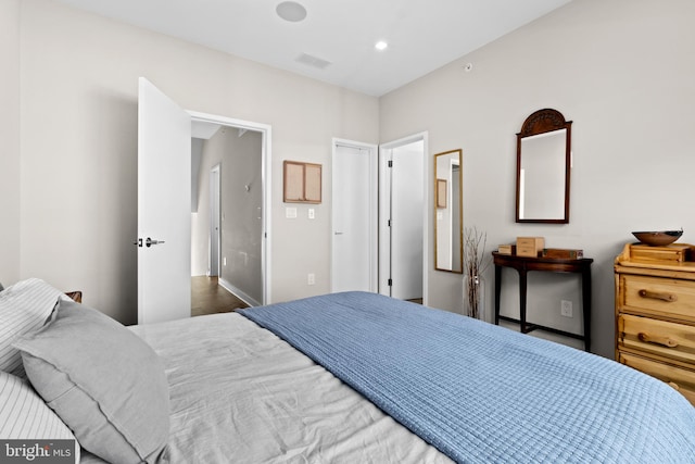 bedroom with dark hardwood / wood-style floors