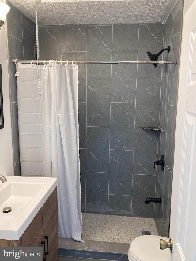 bathroom with toilet, vanity, and a shower with curtain