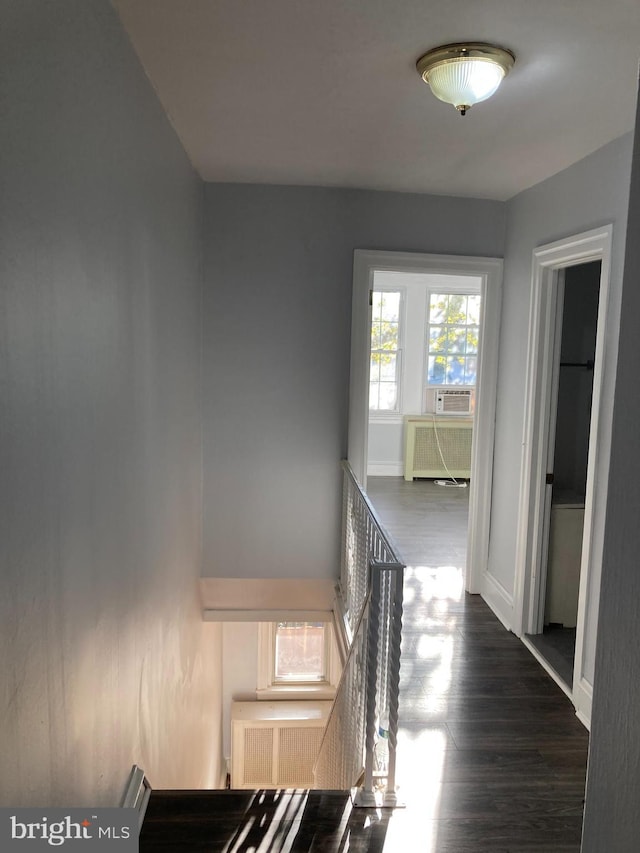 staircase featuring radiator, hardwood / wood-style floors, and cooling unit