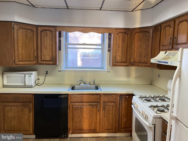 kitchen featuring light tile patterned floors, sink, and white appliances