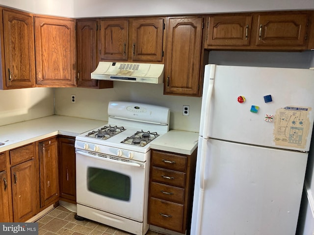 kitchen with light tile patterned floors and white appliances