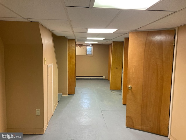 interior space featuring a paneled ceiling and a baseboard radiator