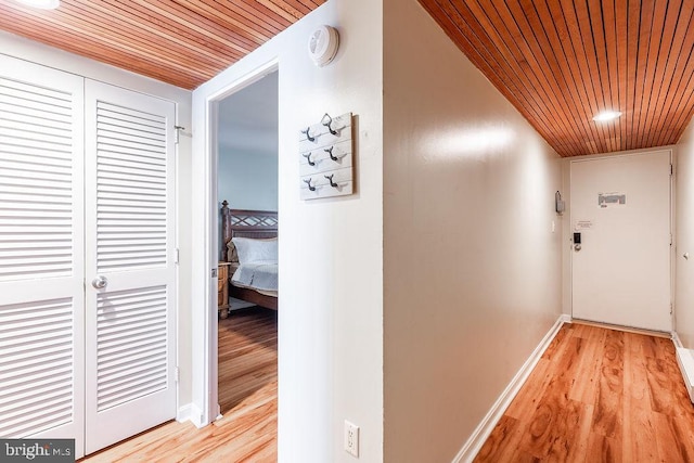 hallway with wooden ceiling and light hardwood / wood-style floors