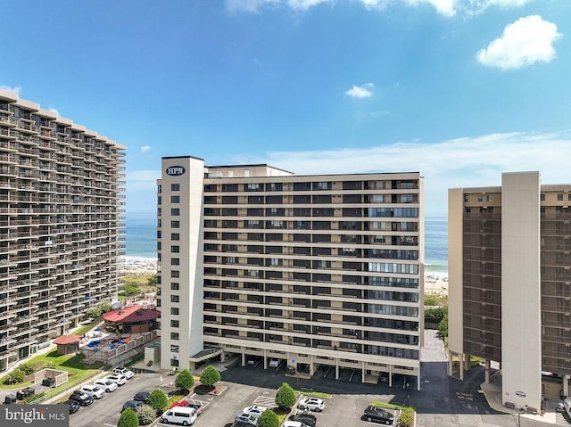 view of building exterior with a view of the beach and a water view