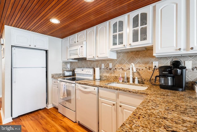 kitchen with light hardwood / wood-style floors, light stone countertops, wooden ceiling, sink, and white appliances