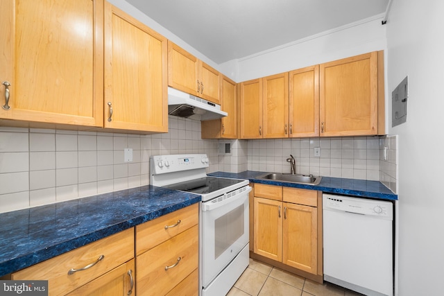 kitchen with light tile patterned floors, under cabinet range hood, white appliances, a sink, and tasteful backsplash