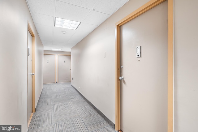 hallway with a drop ceiling