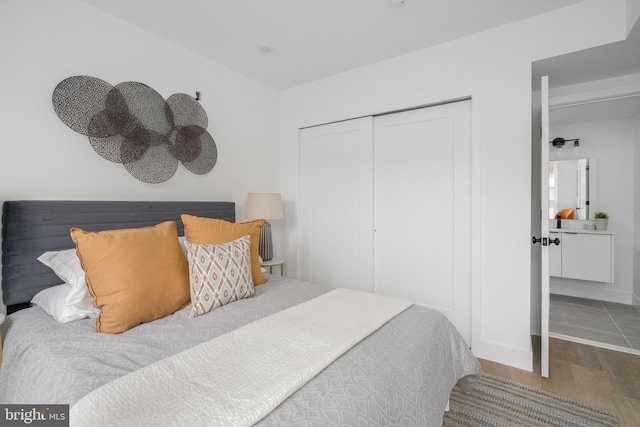 bedroom with wood-type flooring and a closet