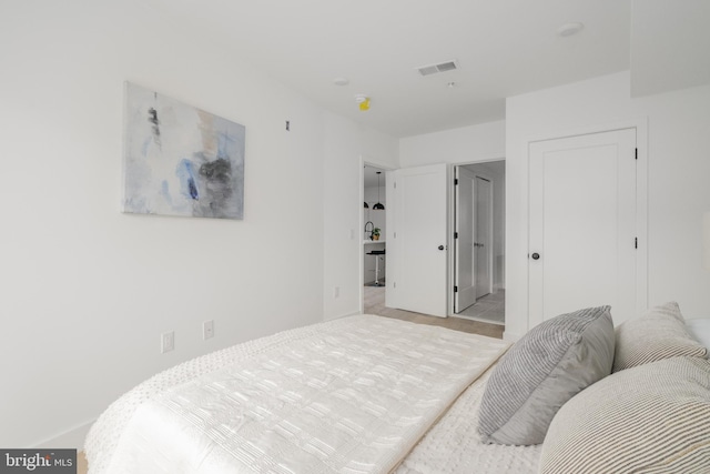 bedroom featuring light colored carpet