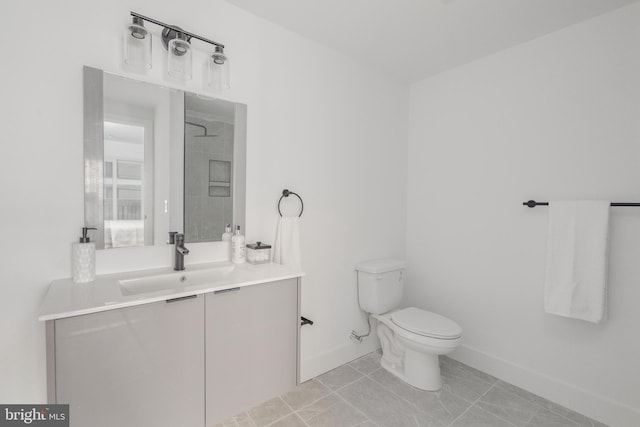 bathroom featuring tile patterned flooring, toilet, and vanity