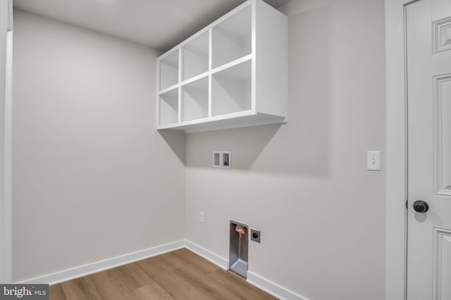 washroom featuring laundry area, baseboards, hookup for an electric dryer, light wood-type flooring, and washer hookup