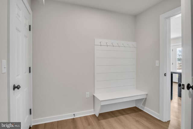 mudroom featuring light wood-style flooring and baseboards