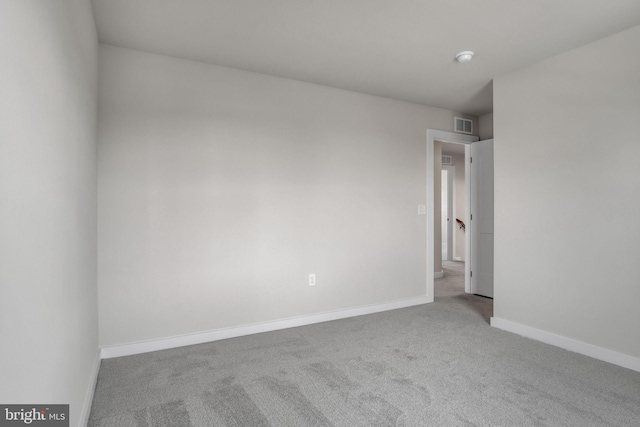 unfurnished room featuring light carpet, visible vents, and baseboards