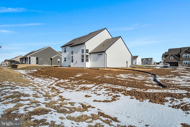 snow covered house with a residential view